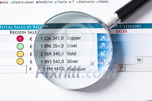 Magnifing glass and documents with analytics data lying on table Magnifing glass and documents with analytics data lying on table