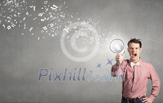 Young funny man screaming emotionally in megaphone