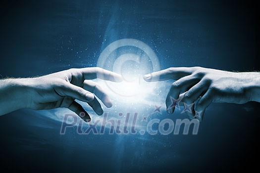Close up of two hands reaching each other with fingers Close up of two hands reaching each other with fingers