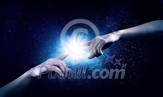 Close up of two hands reaching each other with fingers Close up of two hands reaching each other with fingers