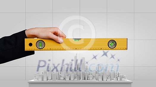 Close up of female hand measuring construction project with ruler Close up of female hand measuring construction project with ruler