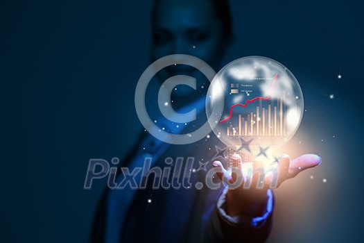 Close up of businesswoman holding bubble with graphs in hand