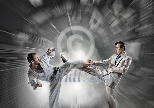 Young determined karate man fighting with businessman in suit