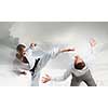 Young determined karate man fighting with businessman in suit