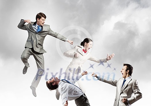 Young determined karate businessman fighting with team of businesspeople