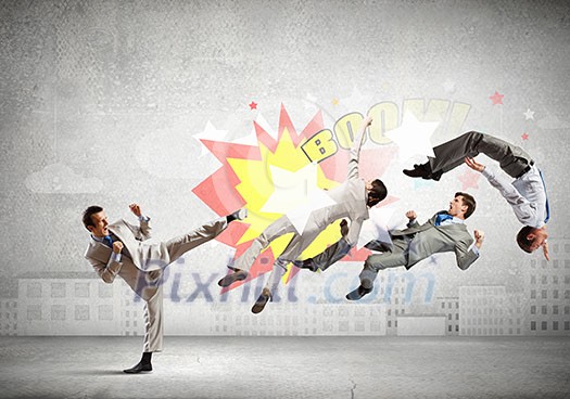 Young determined karate businessman fighting with team of businesspeople Young determined karate businessman fighting with team of businesspeople