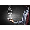 Hand of businessman holding dna molecule concept