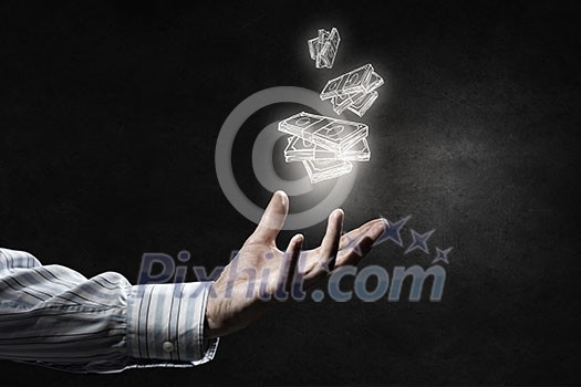 Businessman hand holding drawn banknotes in palm on dark background Businessman hand holding drawn banknotes in palm on dark background