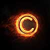 Glowing fire copyright sign on dark background