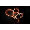 Glowing love hearts symbols on dark background
