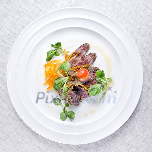 fried meat with vegetables on the plate isolated on white fried meat with vegetables on the plate isolated on white