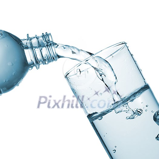 water pouring into glass from bottle isolated on white water pouring into glass from bottle isolated on white