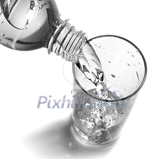 water pouring into glass from bottle isolated on white water pouring into glass from bottle isolated on white
