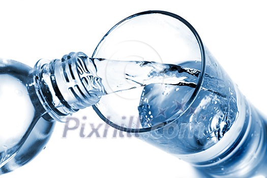 water pouring into glass from bottle isolated on white water pouring into glass from bottle isolated on white