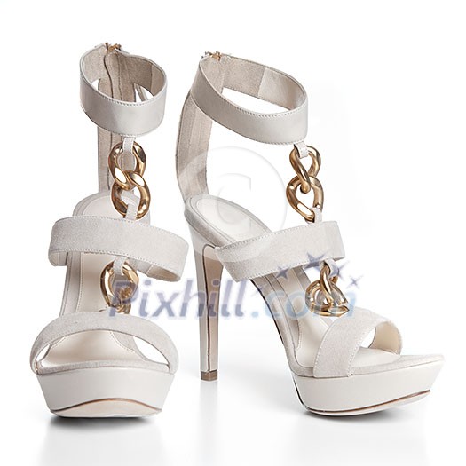 White leather female shoes on high heels isolated on white