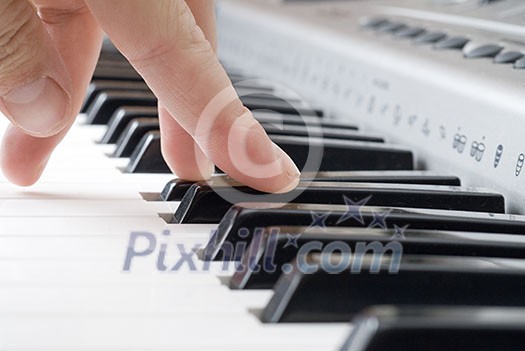 hand playing music on the piano