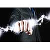 Close up of businessman hand holding lightning in fist