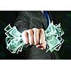 Close up of businessman hand clenching money banknotes in fist