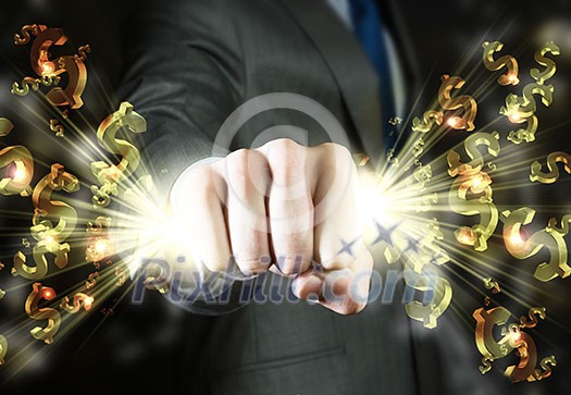Close up of businessman hand clenching dollar signs in fist Close up of businessman hand clenching dollar signs in fist