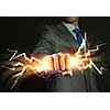 Close up of businessman hand holding lightning in fist