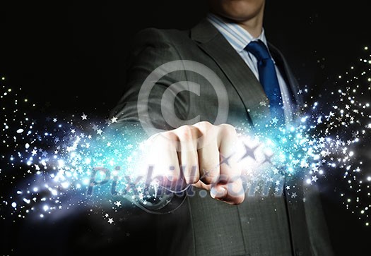 Close up of businessman hand holding light ray in fist Close up of businessman hand holding light ray in fist