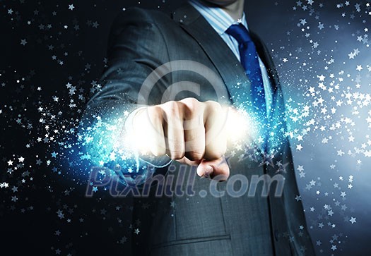 Close up of businessman hand holding light ray in fist Close up of businessman hand holding light ray in fist