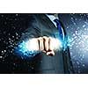 Close up of businessman hand holding light ray in fist