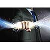 Close up of businessman hand holding light ray in fist