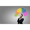Young thoughtful businesswoman and colorful speech bubbles above