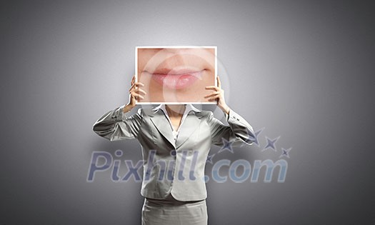 Businesswoman holding banner with macro mouth image Businesswoman holding banner with macro mouth image