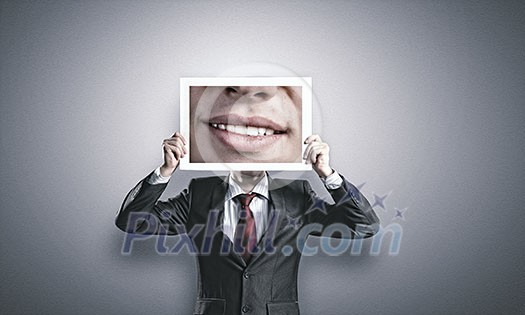 Businessman hiding head behind photo with huge mouth Businessman hiding head behind photo with huge mouth