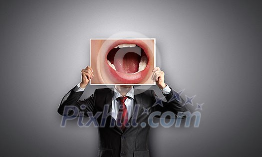 Businessman hiding head behind photo with huge mouth Businessman hiding head behind photo with huge mouth