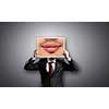 Businessman hiding head behind photo with huge mouth