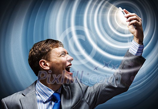 Aggressive businessman screaming fiercely in mobile phone Aggressive businessman screaming fiercely in mobile phone