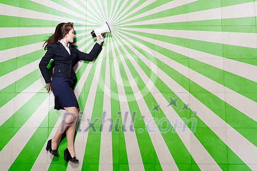 Funny businesswoman lying on floor businesswoman holding megaphone Funny businesswoman lying on floor businesswoman holding megaphone