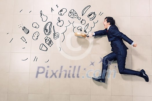 Young funny businessman running with pan in hand