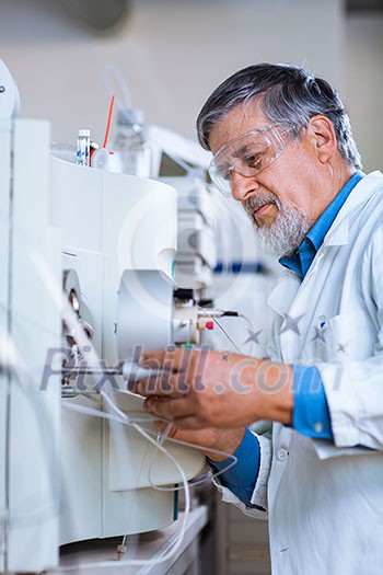 Senior male researcher carrying out scientific research in a lab (shallow DOF; color toned image)