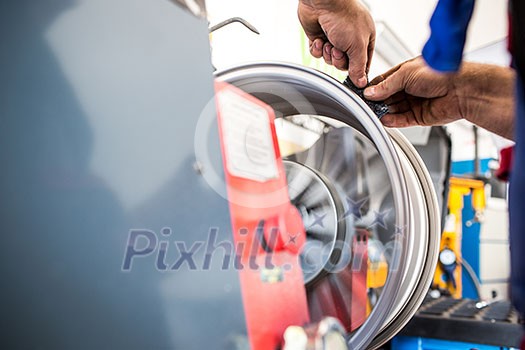 Inside a garage - changing wheels/tires (shallow DOF; color toned image)