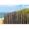 Old wooden fence on a beach in Brittany, France