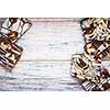 Assorted chocolate caramel bark pieces arranged on wooden background from above with copy space