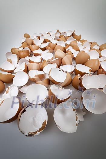 Pile of many broken brown empty eggshells