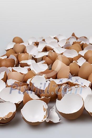 Pile of many broken brown empty eggshells Pile of many broken brown empty eggshells