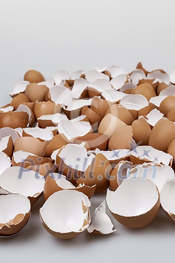 Pile of many broken brown empty eggshells