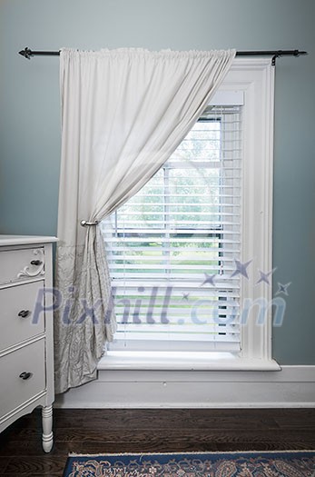 Window with venetian blinds and white curtain in country style room Window with venetian blinds and white curtain in country style room