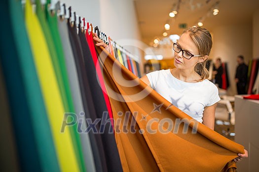 Pretty young woman choosing the right material/color for her modern appartement interior (shallow DOF; color toned image) Pretty young woman choosing the right material/color for her modern appartement interior (shallow DOF; color toned image)