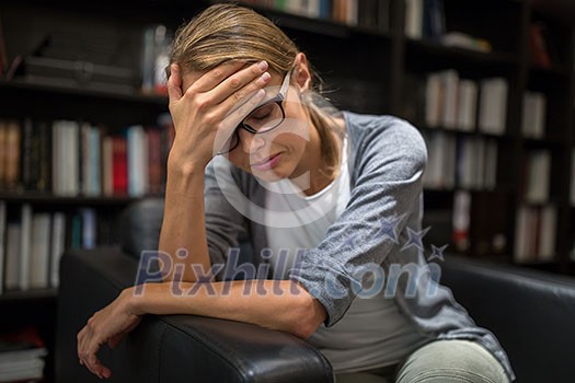 Woman suffering from depression Sitting in a chair (shallow DOF)