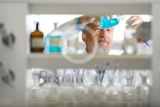 Senior male researcher carrying out scientific research in a lab (shallow DOF; color toned image) Senior male researcher carrying out scientific research in a lab (shallow DOF; color toned image)