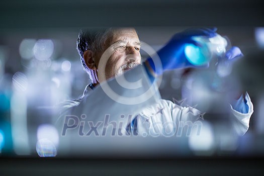 Senior male researcher carrying out scientific research in a lab (shallow DOF; color toned image) Senior male researcher carrying out scientific research in a lab (shallow DOF; color toned image)