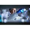 Senior male researcher carrying out scientific research in a lab (shallow DOF; color toned image)