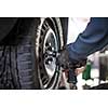 Inside a garage - changing wheels/tires (shallow DOF; color toned image)